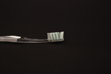 Toothbrush on a black background, minimalism