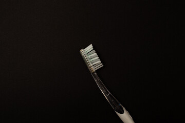 Toothbrush on a black background, minimalism