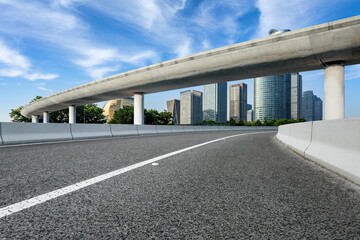 Asphalt road and city skyline with modern buildings in Hangzhou, China.