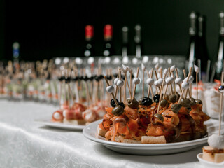 Decorated catering banquet table with different food appetizers assortment on a party