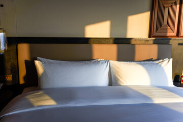 Closeup of bedside pillows in hotel room