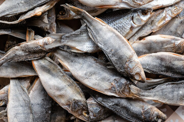 Sun dried fish. Stock-fish on the brown paper.