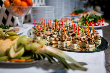 Decorated catering banquet table with different food appetizers assortment on a party
