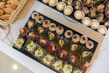 Decorated catering banquet table with different food appetizers assortment on a party