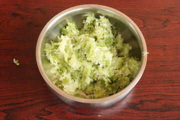 Fresh Green Mango fruit Pachadi isolated on Wood background