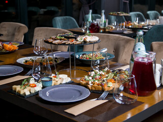 Decorated catering banquet table with different food appetizers assortment on a party