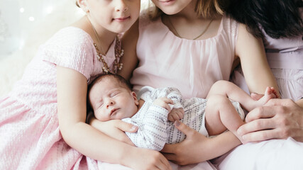 happy family and a newborn baby in the hands of his older sister.