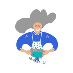 A happy elderly woman kneads dough and films herself on a phone camera.