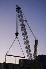 The silhouette of a crane at a construction site in Paris.