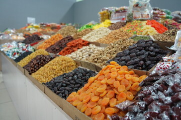 Almaty, Kazakhstan - 12.23.2021 : Various dried fruits in containers on an open counter in a hypermarket - obrazy, fototapety, plakaty