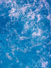 Fototapeta na wymiar Stylish blue water texture background. Jacuzzi bubbles. Trendy vertical nature wallpapers