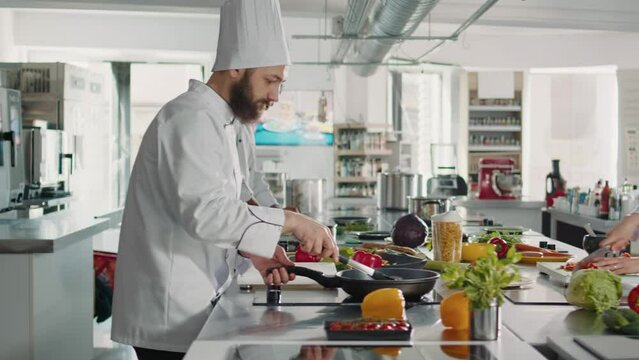 Authentic chef cooking meat steak in frying pan on stove, using kitchen utensils and tasty ingredients. Male cook preparing meal with culinary recipe for restaurant food menu cuisine.