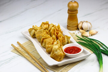Siomay Goreng or Pangsit Goreng, Indonesian popular street food, made from fish and shrimp wrapped...