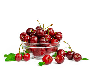 Heap of sweet red cherries in a bowl with mint leaves.