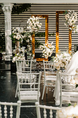 wedding decor of white flowers for the ceremony on the street