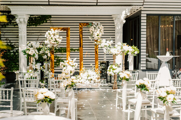 wedding decor of white flowers for the ceremony on the street