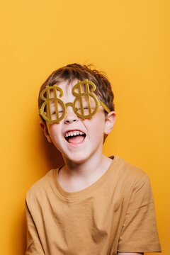 Smiling Boy Dressed Up With Money Glasses