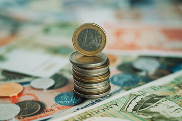 stack of euro coins with euro coin on top with blurred background and other money background