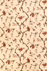 Vintage wallpaper with branches and flowers faded and bleached by sunlight