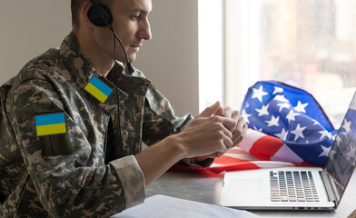 Ukrainian man warrior dressed in a military pixel uniform the yellow-blue flag of Ukraine