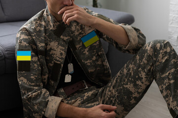 Ukrainian man warrior dressed in a military pixel uniform the yellow-blue flag of Ukraine