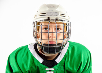 Portrait of a youth hockey player wearing helmet and uniform