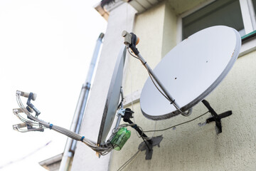 satellite dish and television antenna on roof top