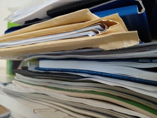 Stack of files, magazines, papers in the office.