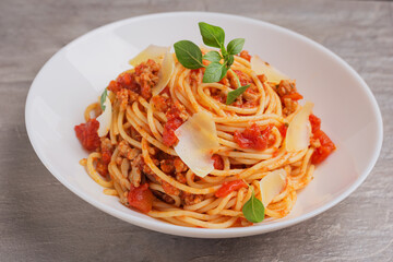 Close up spaghetti bolognese on white plate ready to eat. Mediterranean cuisine.
