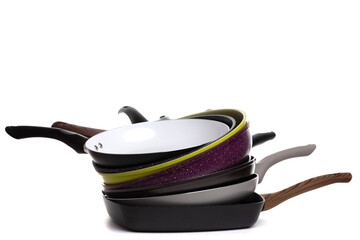 stack of new stylish modern non-stick frying pans on white background