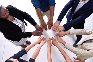 Theyve unlocked the secret to success. High angle shot of a group of unidentifiable businesspeople making a circle with their hands in the office.