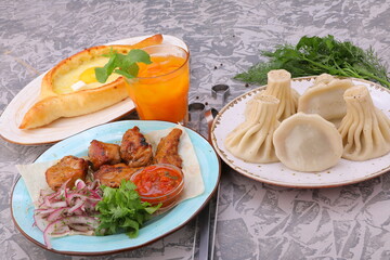 the national Georgian dish khachapuri and khinkali on the table in plates and lamb kebab