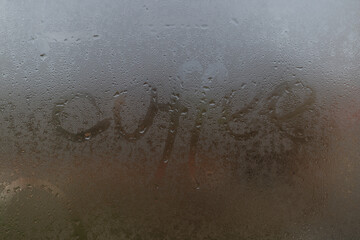 word coffee on a foggy window