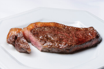 Barbecue meat steak on a white plate. Brazilian barbecue.