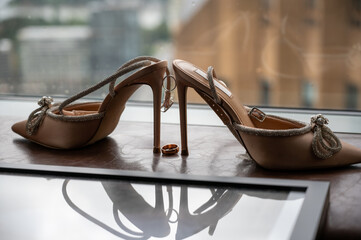 pair of shoes and wedding rings 