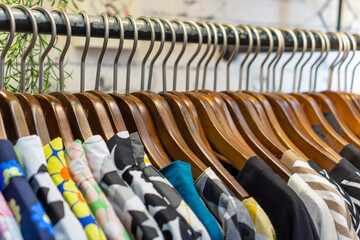 Fototapeta premium Clothes hanging on rack in fashion store.