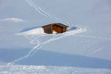 Lonely house in snow valley in Alps