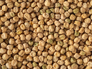 Food-grade natural textured background of yellow dried pea seeds. Pea background. Close-up of whole organic dry peas Top View