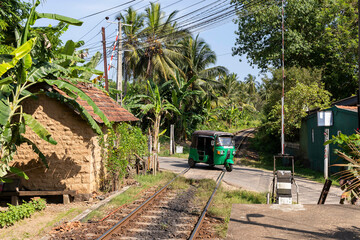Sri Lanka. Unawatuna. Transport tuk-tuk at a railway crossing.