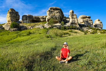 A girl on the background of a picturesque view of the Bakhchisarai sphinxes in summer....