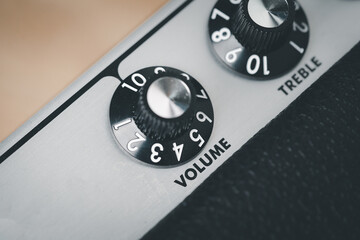 Volume control knob of a black amplifier on audio mixing console volume in a stereo