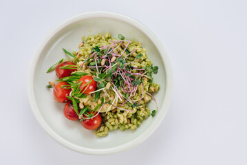 Pearl barley dish with cherry tomatoes and microgreens. Diet menu