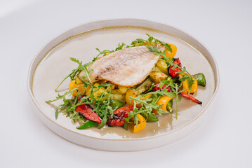 White fish dish with cherry tomatoes, lettuce, microgreens and sesame seeds