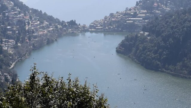 Full view of Naini Lake during evening time near Mall Road in Nainital, Uttarakhand, India, Beautiful view of mountains and blue sky at Nainital Lake side