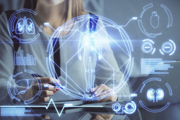 Double exposure of woman hands typing on computer and general theme hologram drawing. Education...