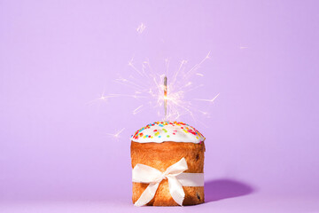 Easter cake with baw and sparkler on red background, easter food. minimal concept