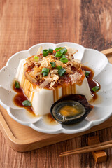 Delicious Chilled tofu and century egg with soy sauce and bonito flakes.