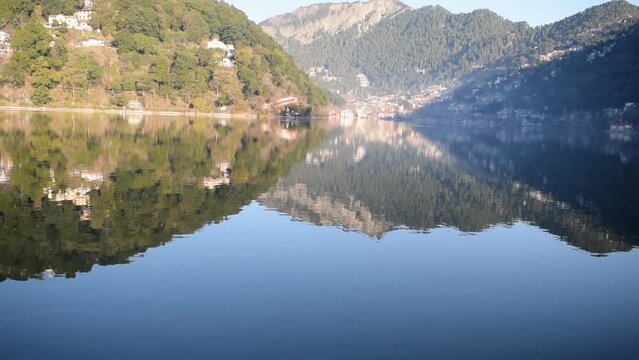 Full view of Naini Lake during evening time near Mall Road in Nainital, Uttarakhand, India, Beautiful view of mountains and blue sky at Nainital Lake side