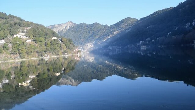 Full view of Naini Lake during evening time near Mall Road in Nainital, Uttarakhand, India, Beautiful view of mountains and blue sky at Nainital Lake side