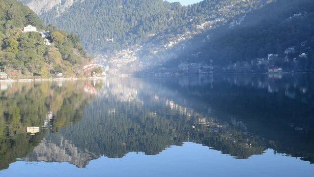 Full view of Naini Lake during evening time near Mall Road in Nainital, Uttarakhand, India, Beautiful view of mountains and blue sky at Nainital Lake side
